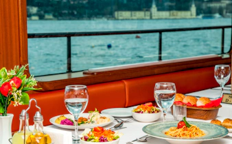 Dinner table set with pasta and salads on Bosphorus Dinner Cruise, Istanbul.