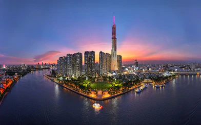 Ho Chi Minh City skyline at sunset with Landmark 81 and Saigon River, Vietnam.