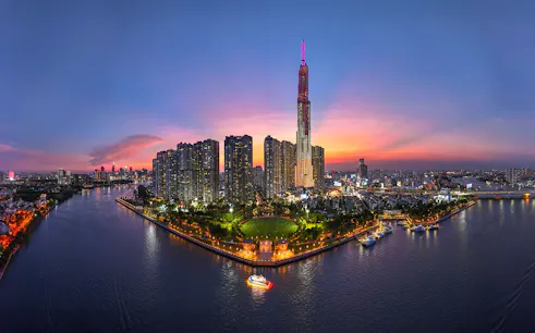 Ho Chi Minh City skyline at sunset with Landmark 81 and Saigon River, Vietnam.