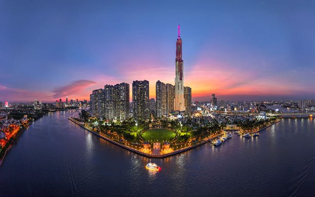 Ho Chi Minh City skyline at sunset with Landmark 81 and Saigon River, Vietnam.