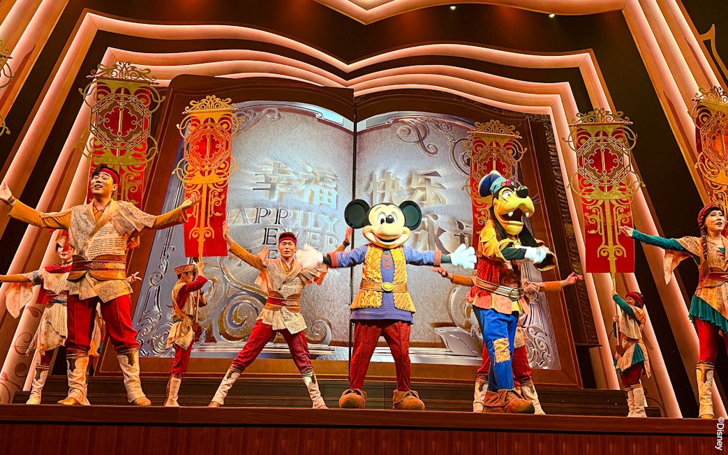 Mickey Mouse and performers on stage at Shanghai Disney show.