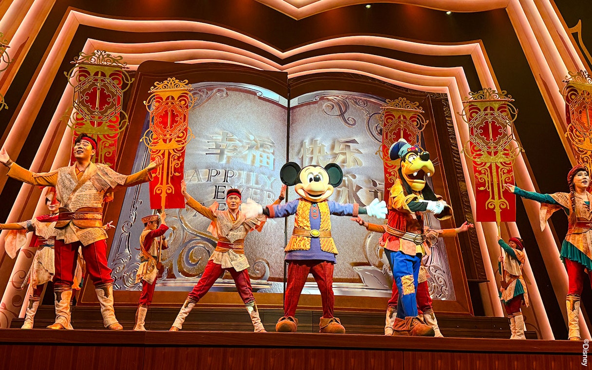 Mickey Mouse and performers on stage at Shanghai Disney show.