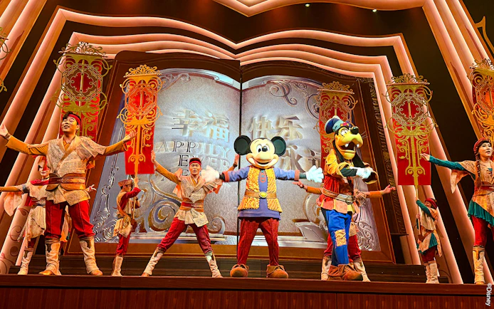 Mickey Mouse and performers on stage at Shanghai Disney show.