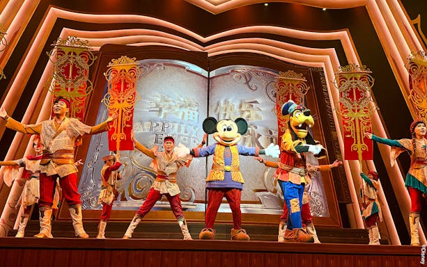 Mickey Mouse and performers on stage at Shanghai Disney show.
