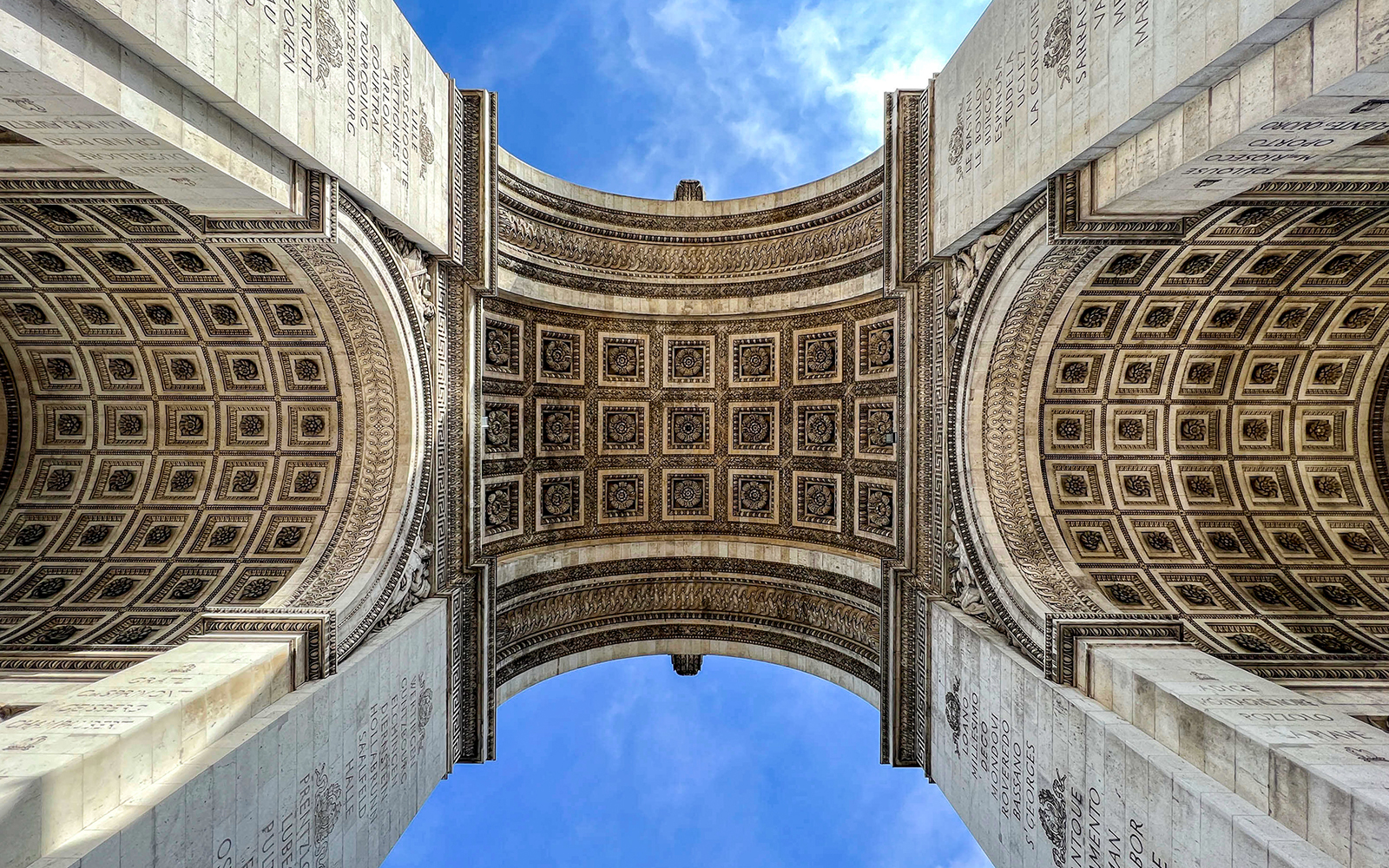 View of the Arc de Triomphe's intricate ceiling in Paris, part of an audio-guided tour.