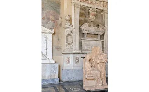 Marble sculptures and ornate wall carvings inside Pisa Cathedral, Italy.