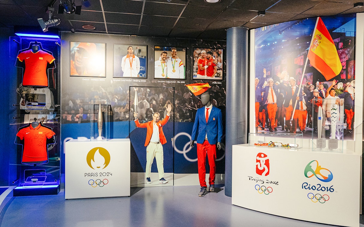 Interiors of the Rafa Nadal Museum Xperience showcasing Olympic memorabilia and Spanish sports attire.