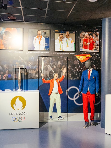 Interiors of the Rafa Nadal Museum Xperience showcasing Olympic memorabilia and Spanish sports attire.