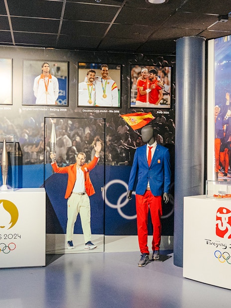 Interiors of the Rafa Nadal Museum Xperience showcasing Olympic memorabilia and Spanish sports attire.