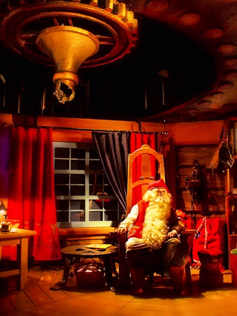 Santa Claus in his cozy office at Rovaniemi Santa Claus Village.