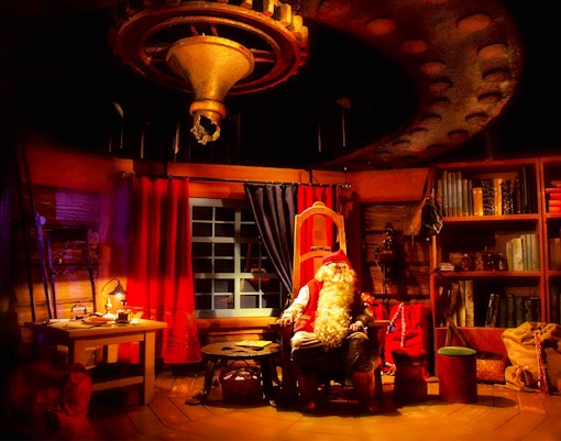 Santa Claus in his cozy office at Rovaniemi Santa Claus Village.