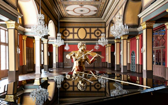 Golden violinist statue in ornate Vienna concert hall with chandeliers.