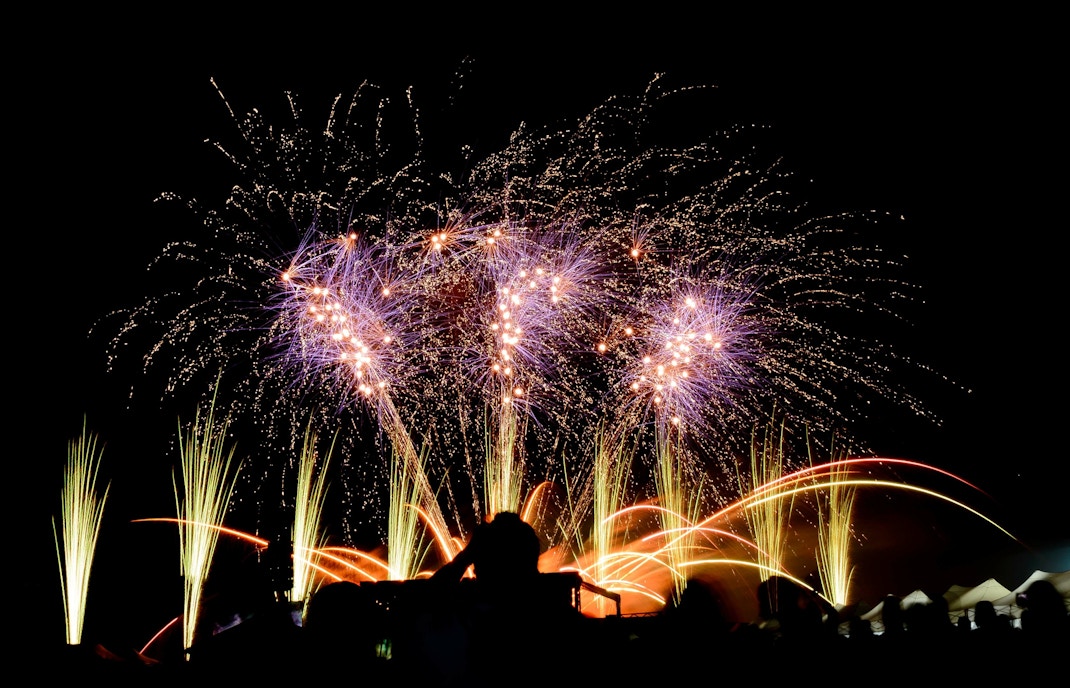 Fireworks display over Melbourne skyline during New Year celebration.