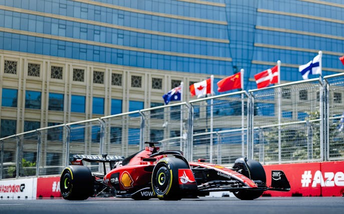 Red Formula 1 car racing on Baku city circuit during Azerbaijan Grand Prix 2026.