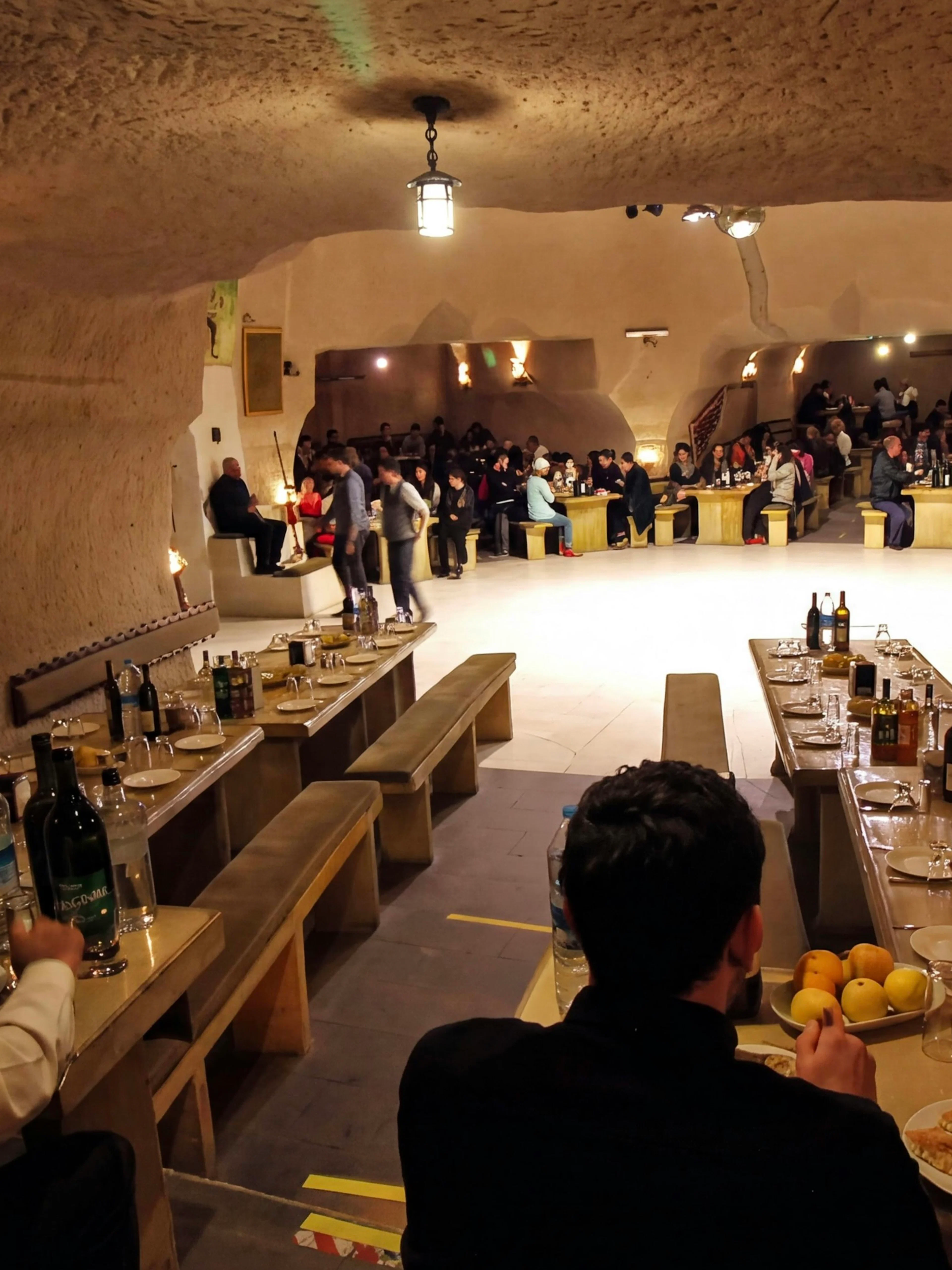 Turkish Night Show in a carved cave restaurant, Cappadocia, with guests dining.