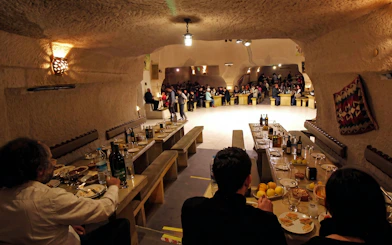 Turkish Night Show in a carved cave restaurant, Cappadocia, with guests dining.