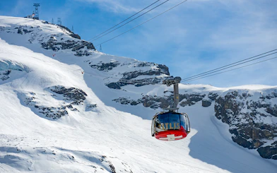 Rotair cable car ascending snowy Mount Titlis on guided tour from Lucerne.