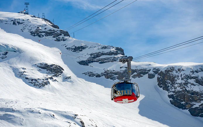 Rotair cable car ascending snowy Mount Titlis on guided tour from Lucerne.