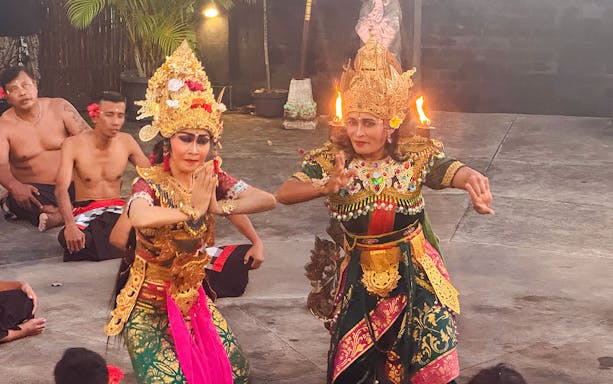 Performers in traditional Balinese attire enact a Ramayana scene outdoors.