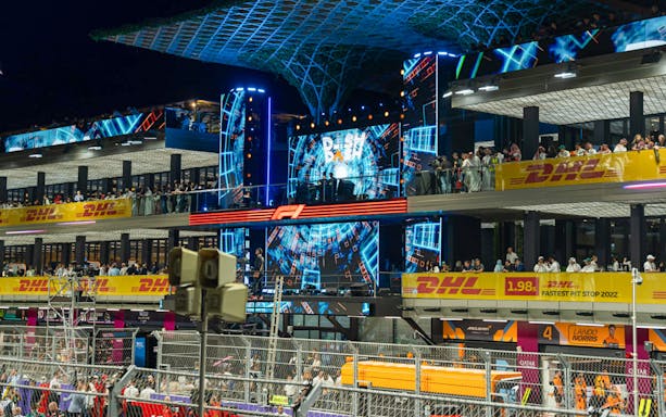 Saudi Arabian Grand Prix DJ area with vibrant lights and crowd.