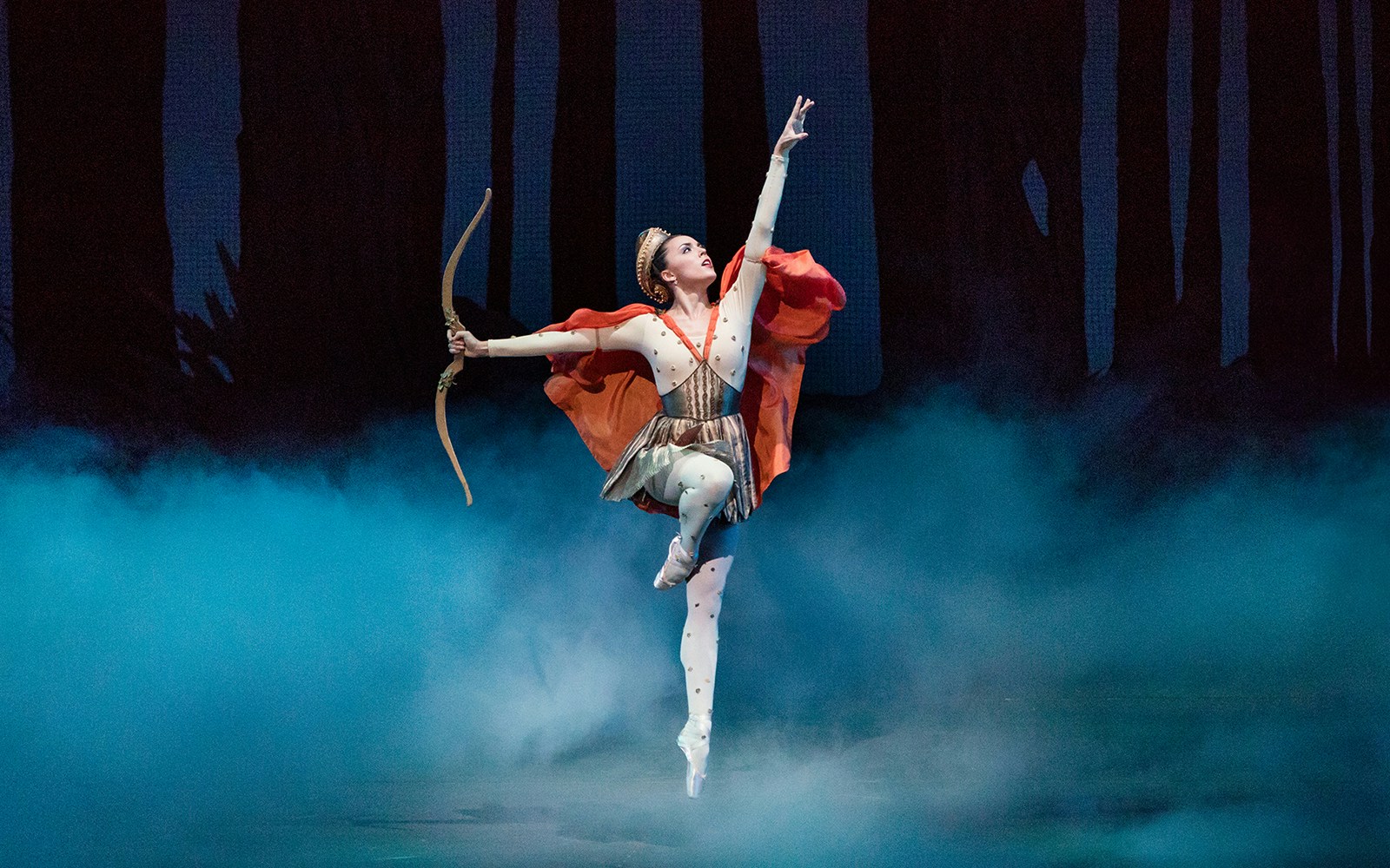Ballet dancer performing with a bow on stage at New York City Ballet.