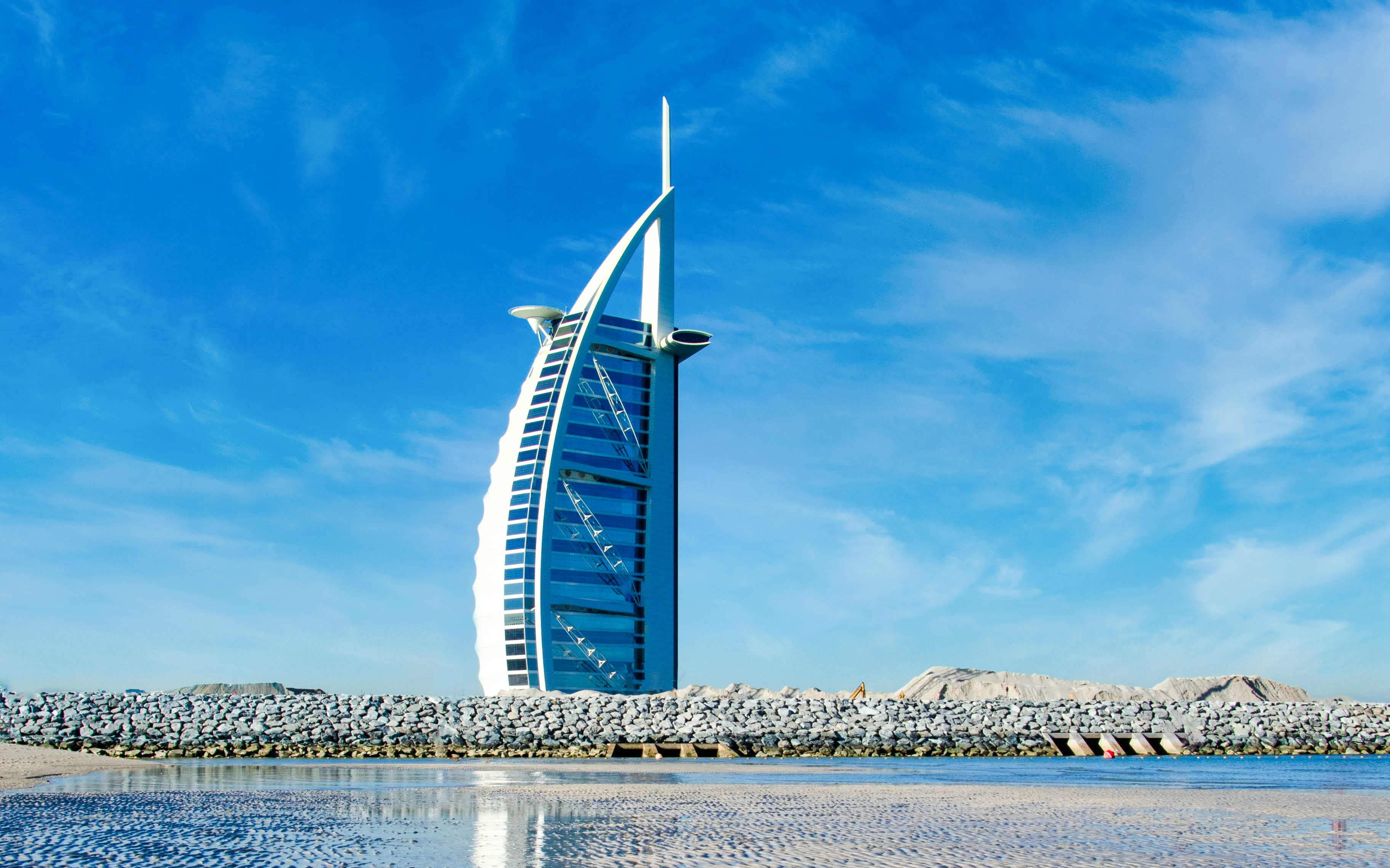 Burj Al Arab hotel against a clear blue sky in Dubai, United Arab Emirates.