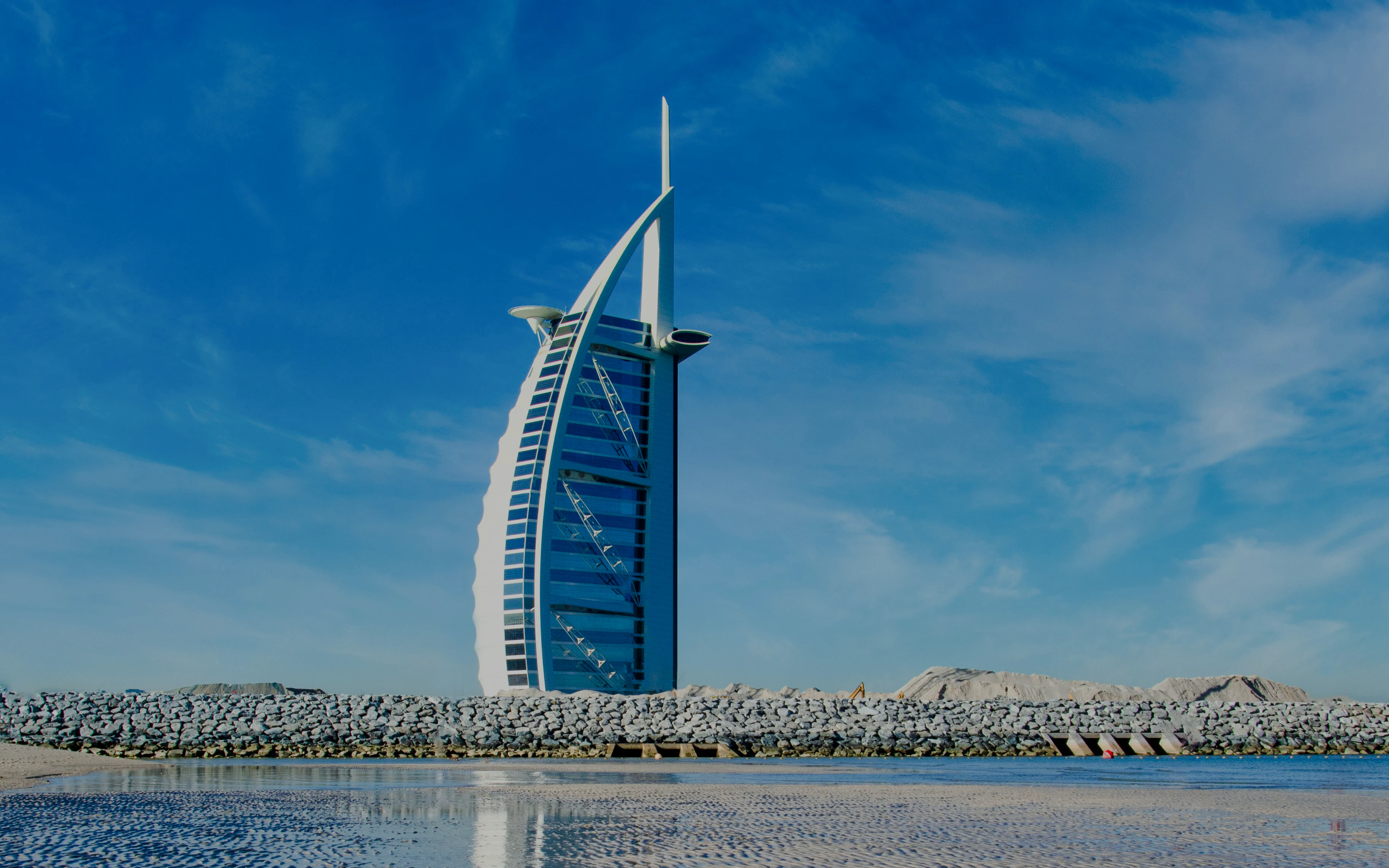Burj Al Arab hotel against a clear blue sky in Dubai, United Arab Emirates.