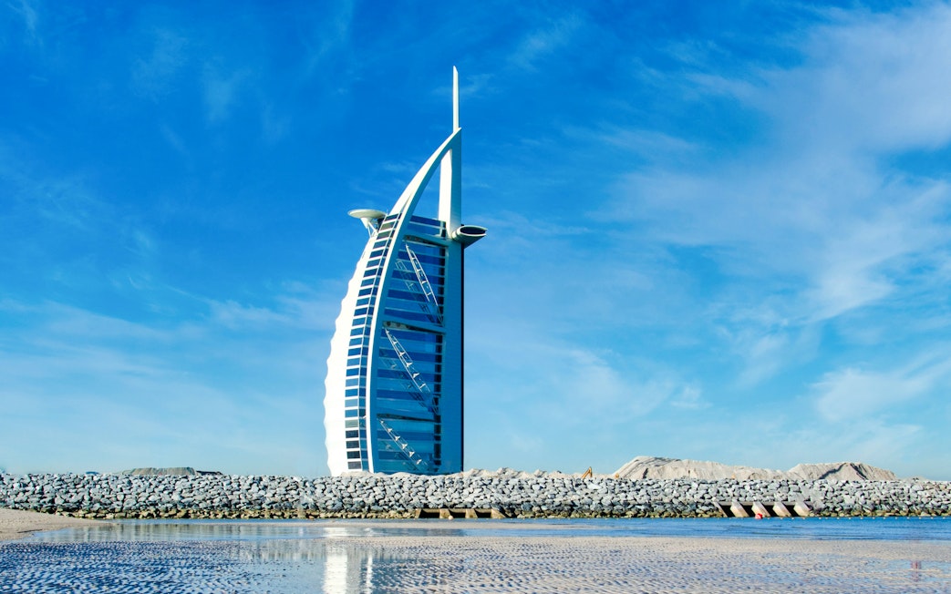 Burj Al Arab hotel against a clear blue sky in Dubai, United Arab Emirates.