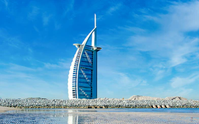 Burj Al Arab hotel against a clear blue sky in Dubai, United Arab Emirates.