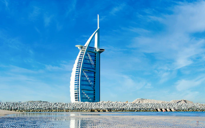 Burj Al Arab hotel against a clear blue sky in Dubai, United Arab Emirates.