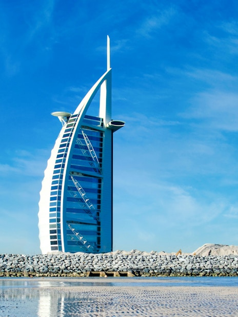 Burj Al Arab hotel against a clear blue sky in Dubai, United Arab Emirates.