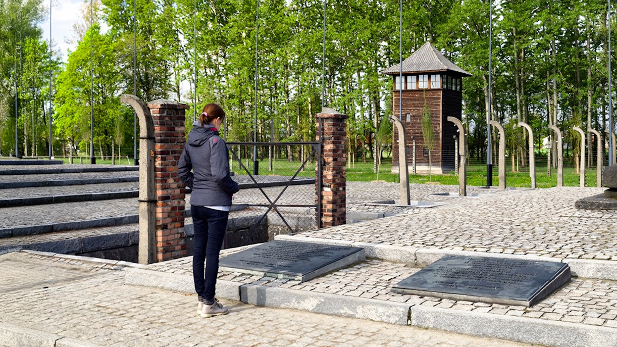 Auschwitz Birkenau watch tower with barbed wire fence in Poland.
