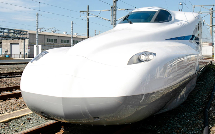 Shinkansen bullet train on tracks in Japan.