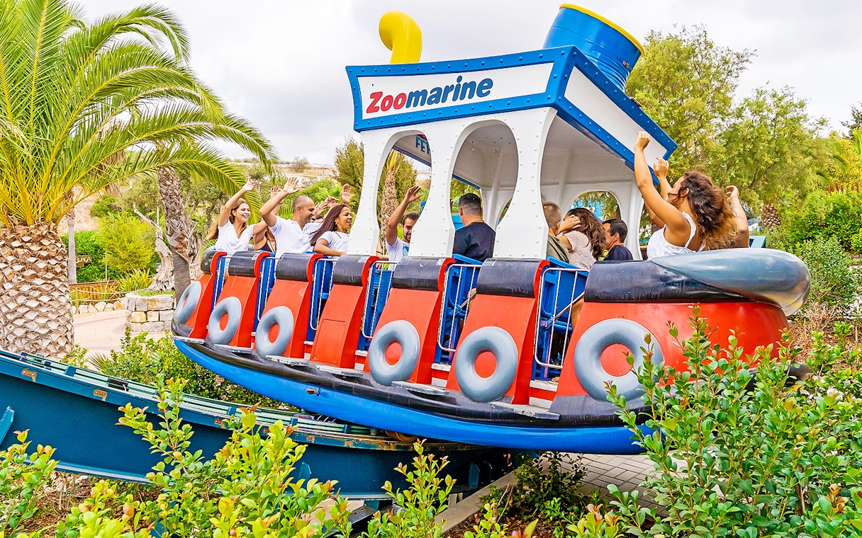 Visitors enjoying a boat-themed ride at Zoomarine Portugal.