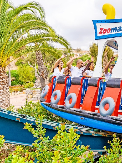 Visitors enjoying a boat-themed ride at Zoomarine Portugal.