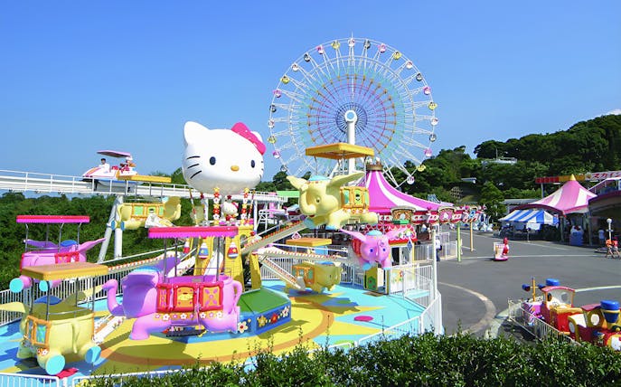 Sanrio Harmonyland amusement park with Hello Kitty ride and Ferris wheel in Japan.