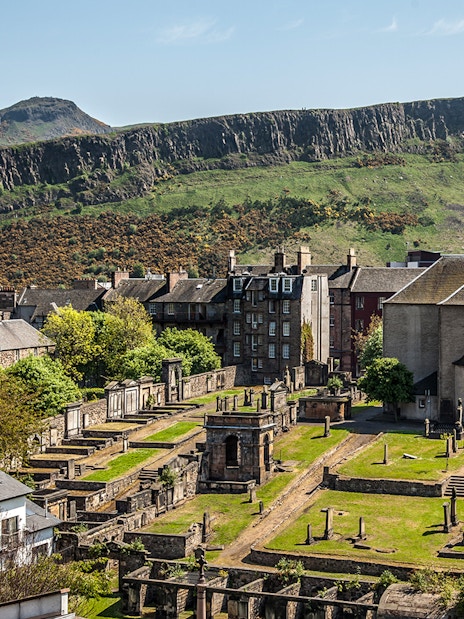 Canongate Kirk and cemetery with Arthur's Seat in the background, Edinburgh.