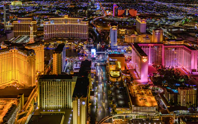 Aerial view of the Las Vegas Strip at night with illuminated hotels and casinos.