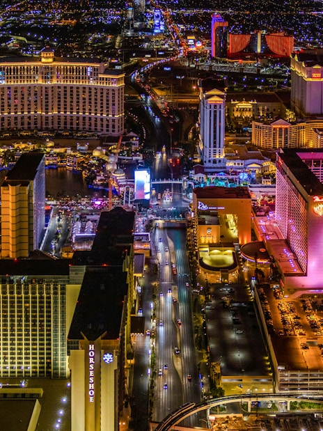 Aerial view of the Las Vegas Strip at night with illuminated hotels and casinos.
