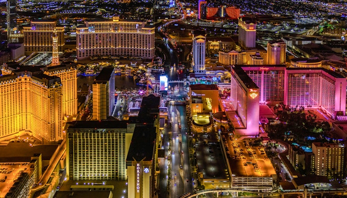 Aerial view of the Las Vegas Strip at night with illuminated hotels and casinos.