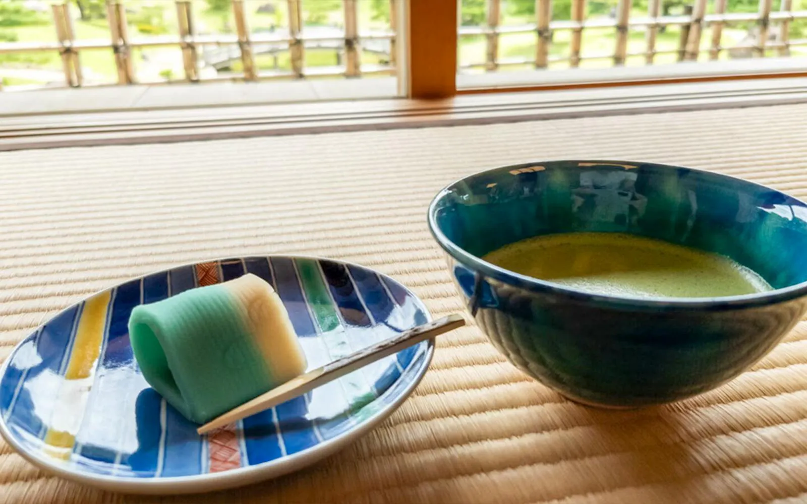 Matcha tea and traditional sweet on tatami mat in Kanazawa tea house.