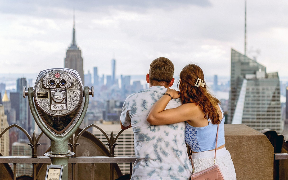Couple enjoying New York City skyline from Top of the Rock Observation Deck.
