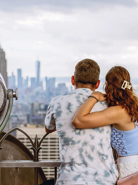 Couple enjoying New York City skyline from Top of the Rock Observation Deck.