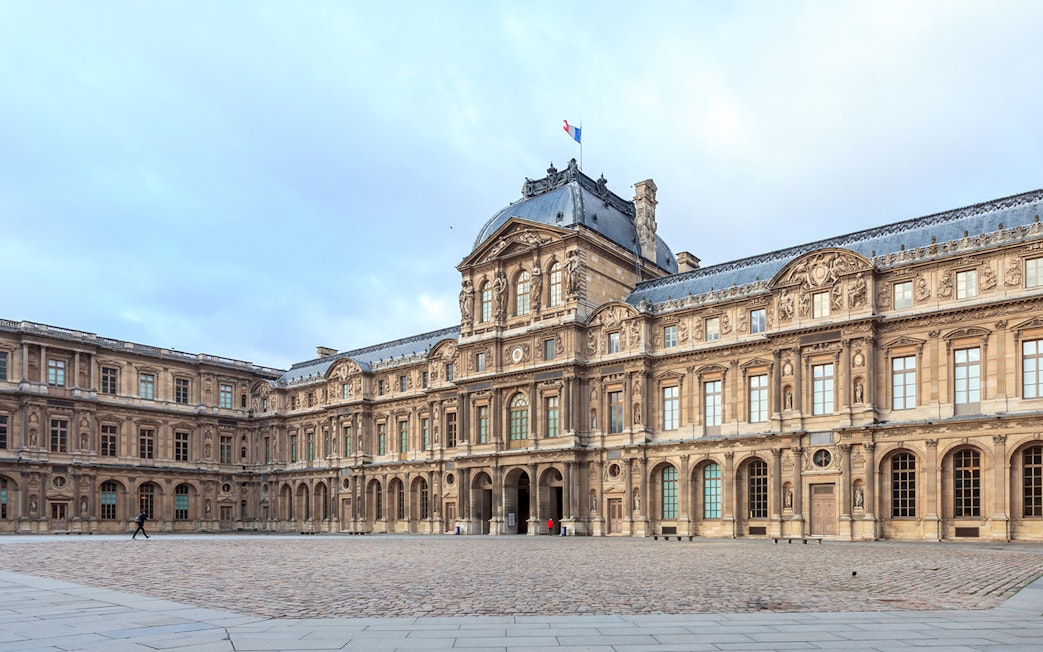 Louvre Museum courtyard in Paris, France, part of a skip-the-line tour with audioguide.
