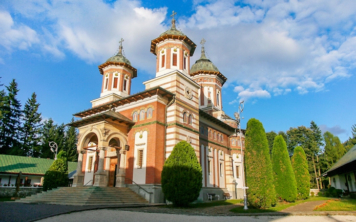 Monastery of Sinaia with Carpathian Mountains backdrop in Sinaia, Romania.