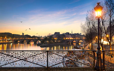 Pont des Arts with evening lights and love locks in Paris.