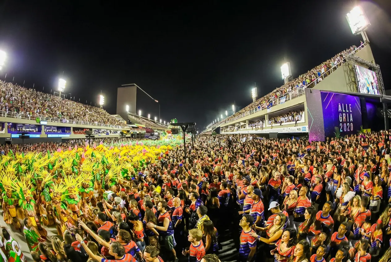 Carnival parade at Sapucaí, Rio de Janeiro, with vibrant costumes and large crowd.