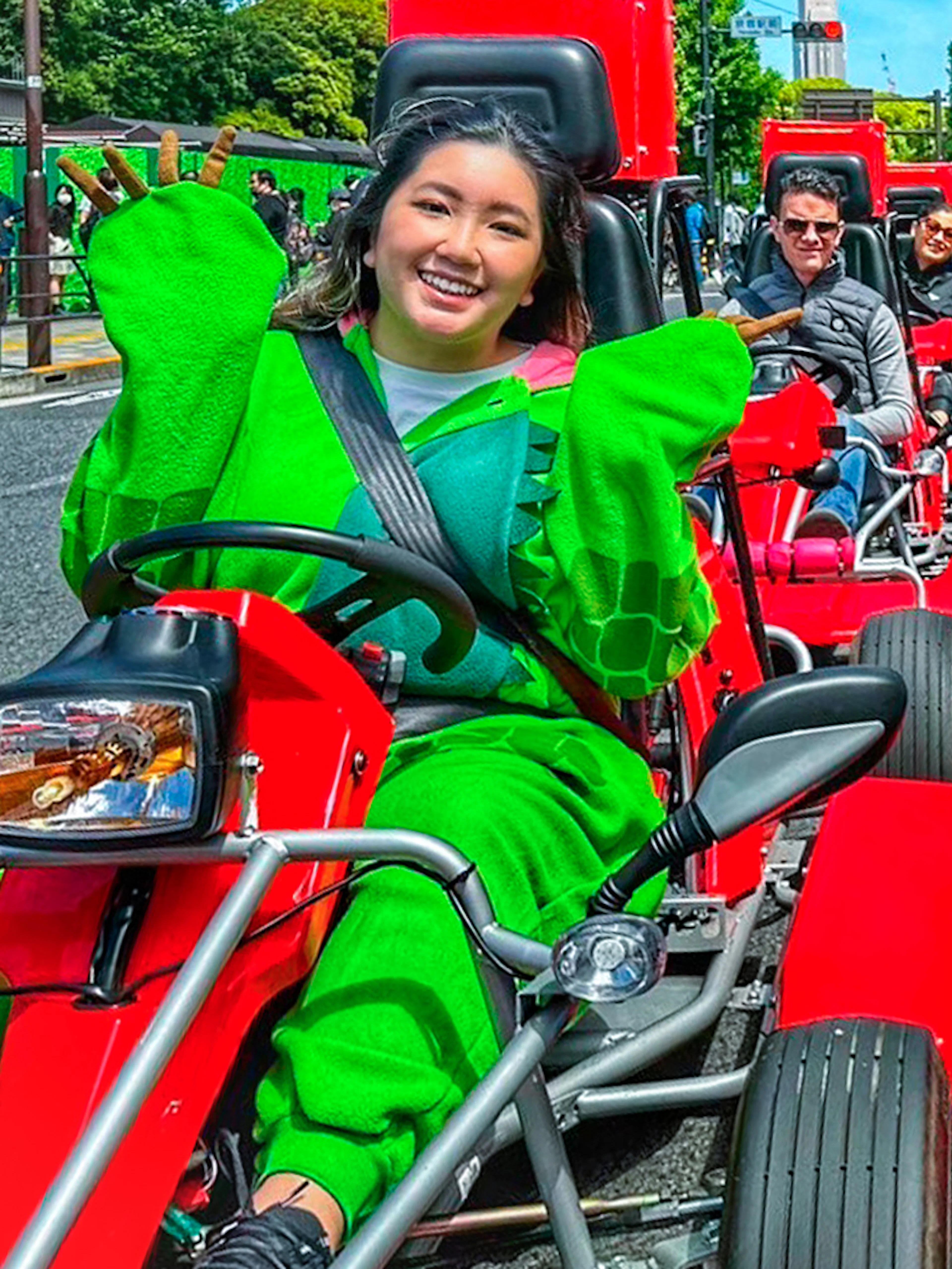 People in costumes driving go-karts on a street in Shibuya, Tokyo.