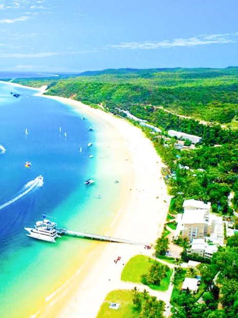 Aerial view of Tangalooma Resort on Moreton Island with sandy beaches and blue waters.