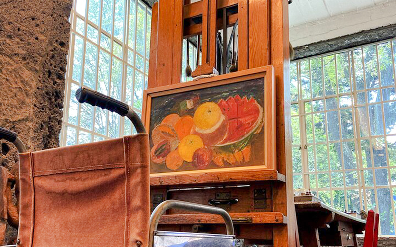 Wheelchair and easel with fruit painting at Frida Kahlo Museum, Mexico City.